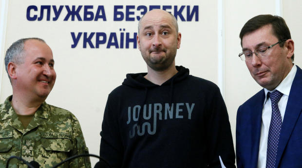 Russian journalist Arkady Babchenko, center, who was reported murdered in the Ukrainian capital on May 29, 2018, Ukrainian Prosecutor General Yuriy Lutsenko, right, and head of the state security service Vasily Gritsak attend a news briefing in Kiev, Ukra 