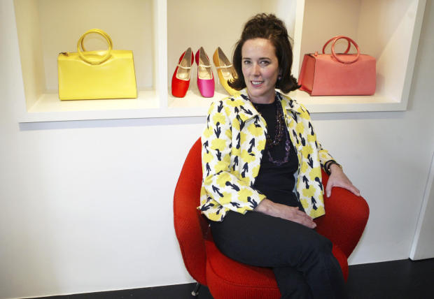Designer Kate Spade poses among handbags and shoes from her collection in New York May 13, 2004. 