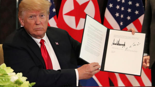 Donald Trump signing U.S.-North Korea summit 