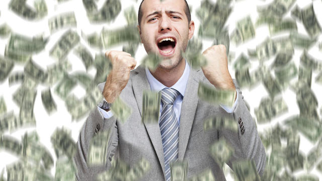 Happy man enjoying the rain of money 