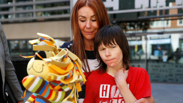 FILE PHOTO: Charlotte Caldwell, and her son Billy, stand outside the Home Office during a break in a meeting with officials to discuss how Billy can have his severe epilepsy treated with cannabis oil, which is a banned substance in Britain, in London 