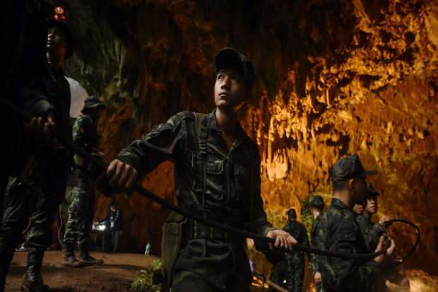 Thai soldiers relay electric cable deep into the Tham Luang cave at the Khun Nam Nang Non Forest Park in Chiang Rai, Thailand, on June 26, 2018, during a rescue operation for a missing children's soccer team and their coach. 