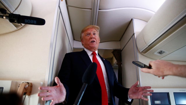 U.S. President Donald Trump speaks to the press aboard Air Force One en route to Bedminster, New Jersey, from Joint Base Andrews 