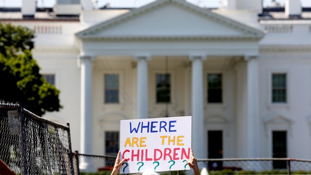 An immigration activists hold signs against family separation during a rally to protest against the Trump Administration's immigration policy outside the White House in Washington 