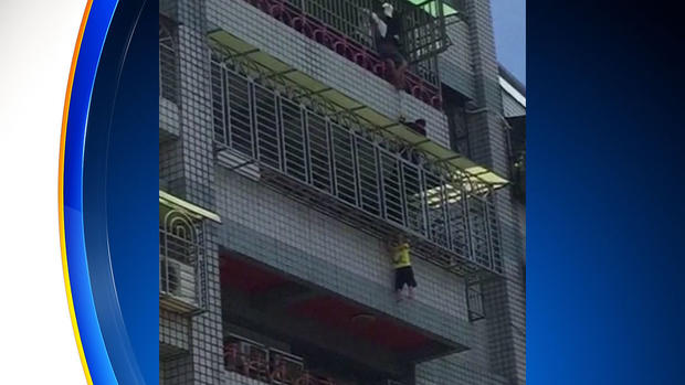child dangles from balcony in Taiwan 