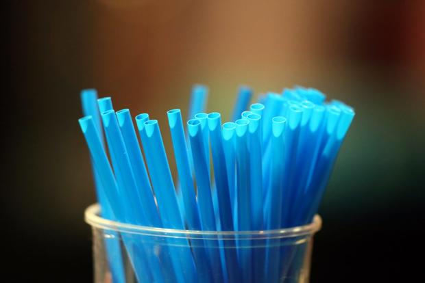 Blue straws in a glass.  France. 