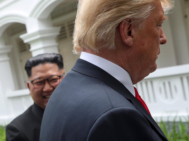 U.S. President Trump and North Korea's Kim walk together before their working lunch during their summit in Singapore 