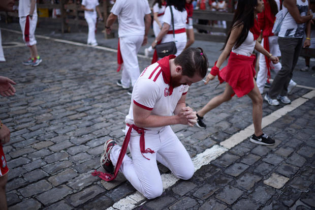 A runner prays before the bull run on the fourth day of the San Fermin festival in Pamplona 