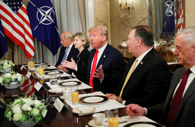 U.S. President Donald Trump gestures as he and U.S. Secretary of Defence James Mattis, U.S. Secretary of State Mike Pompeo attend a bilateral breakfast with NATO Secretary General Jens Stoltenberg ahead of the NATO Summit in Brussels 
