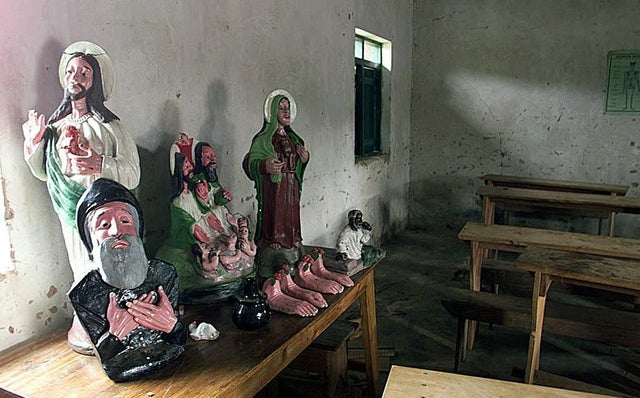 Religious statues ornament a table 19 March 2000 i