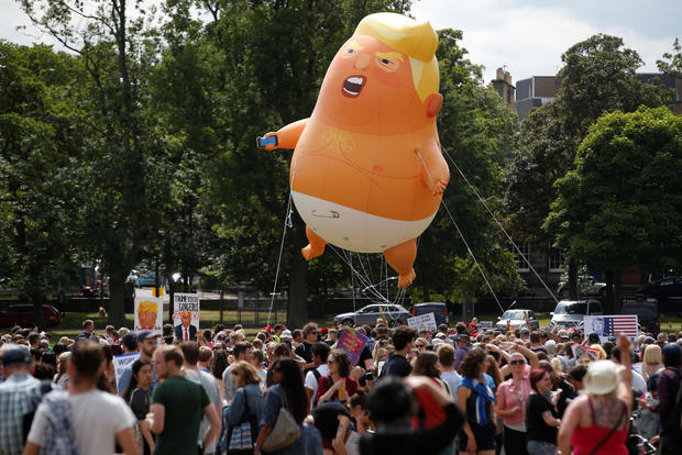 A blimp resembling U.S. President Donald Trump floats above demonstrators marching to protest against the visit of Trump, in Edinburgh 