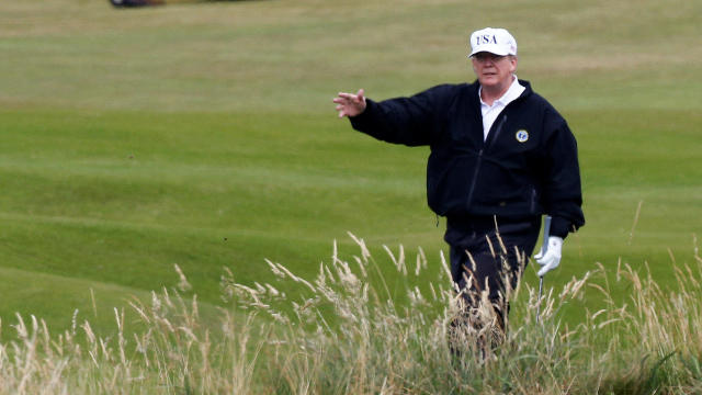U.S. President Donald Trump gestures as he walks on the course of his golf resort, in Turnberry 