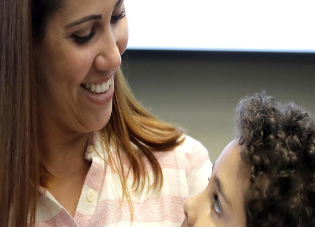 Lidia Karine Souza and her son Diogo De Olivera Filho smile at each other at the Mayer Brown law firm during a news conference shortly after Diogo was reunited with his mother June 28, 2018, in Chicago. 