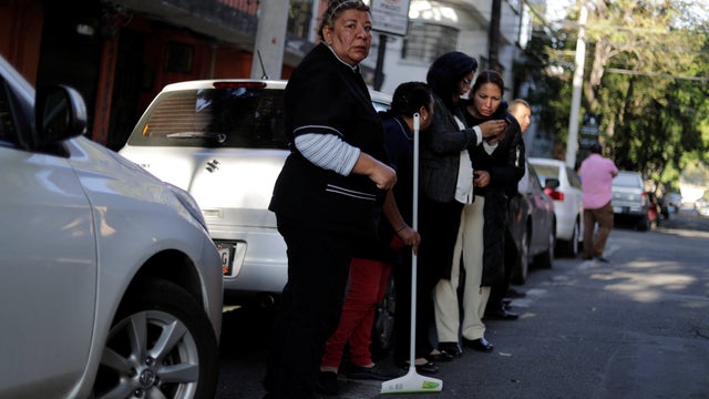 People wait outside their homes after an earthquake was felt in Mexico City, Mexico, July 19, 2018. 