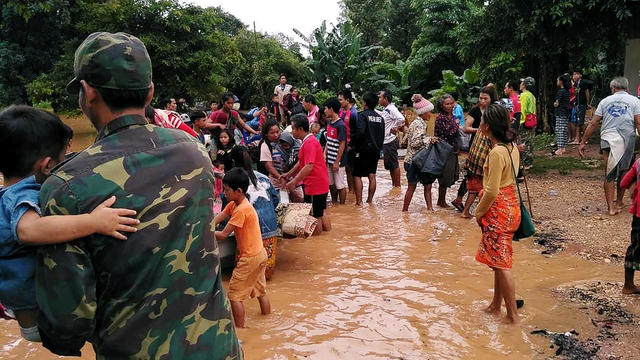 Villagers carry their belonging as they evacuate after the Xepian-Xe Nam Noy hydropower dam collapsed in Attapeu province 