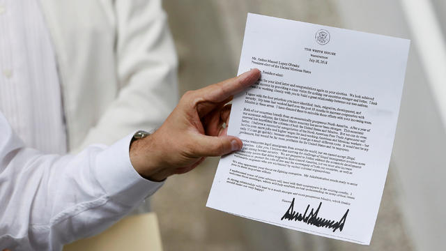 Marcelo Ebrard, picked by Mexico's president-elect Andres Manuel Lopez Obrador as foreign minister, shows the letter sent by U.S. President Donald Trump during a news conference at his campaign headquarters in Mexico City 