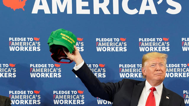 U.S. President Trump holds up "Make Our Farmers Great Again" cap at roundtable discussion at Northeast Iowa Community College in Peosta, Iowa 