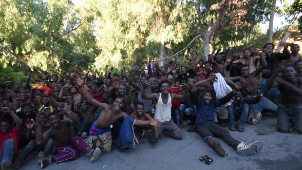 African migrants react in this still image from video after crossing the border from Morocco to Spain's North African enclave of Ceuta 