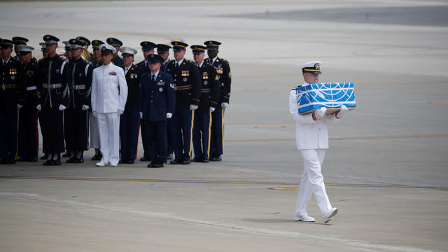 A soldier carries a casket containing the remains of a U.S. soldier who was killed in the Korean War during a ceremony at Osan Air Base in Pyeongtaek 