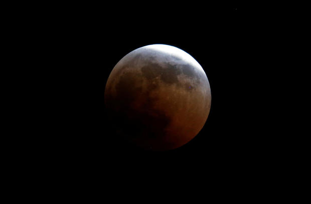 A lunar eclipse of a full "Blood Moon" rises near the Oloitoktok town along the Kenya-Tanzania border 