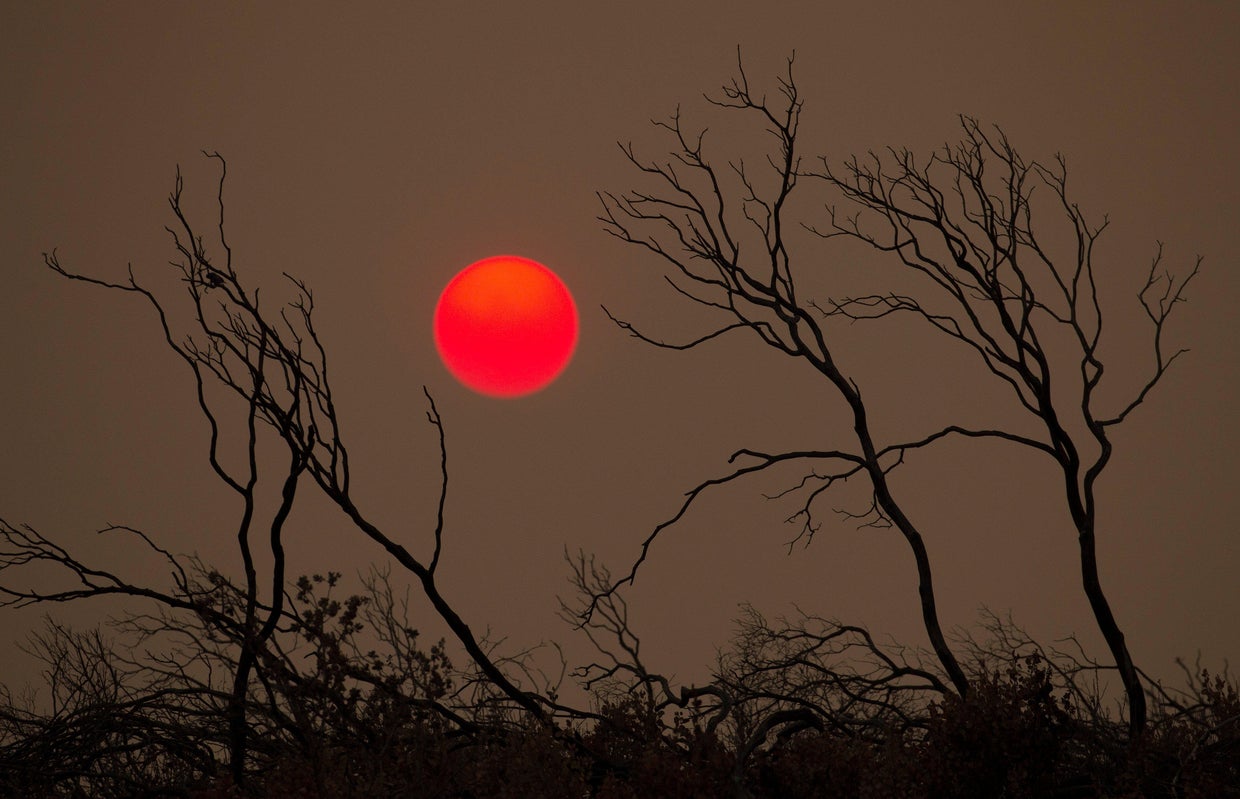 The suns sets over hills burned by the Carr Fire west of Redding 