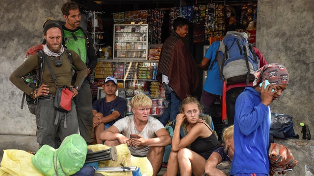 Indonesian and foreign climbers are seen after walking down from Rinjani Mountain at Sembalun village in Lombok Timur 