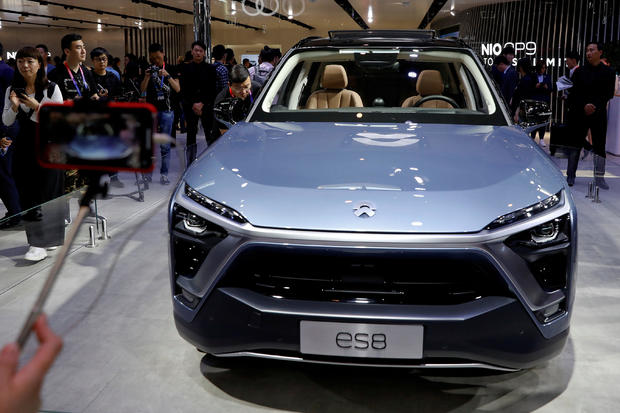 FILE PHOTO: Visitors check NIO ES8 displayed during a media preview of the Auto China 2018 motor show in Beijing 