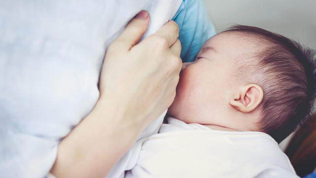 Closeup of mother breastfeeding her newborn baby 