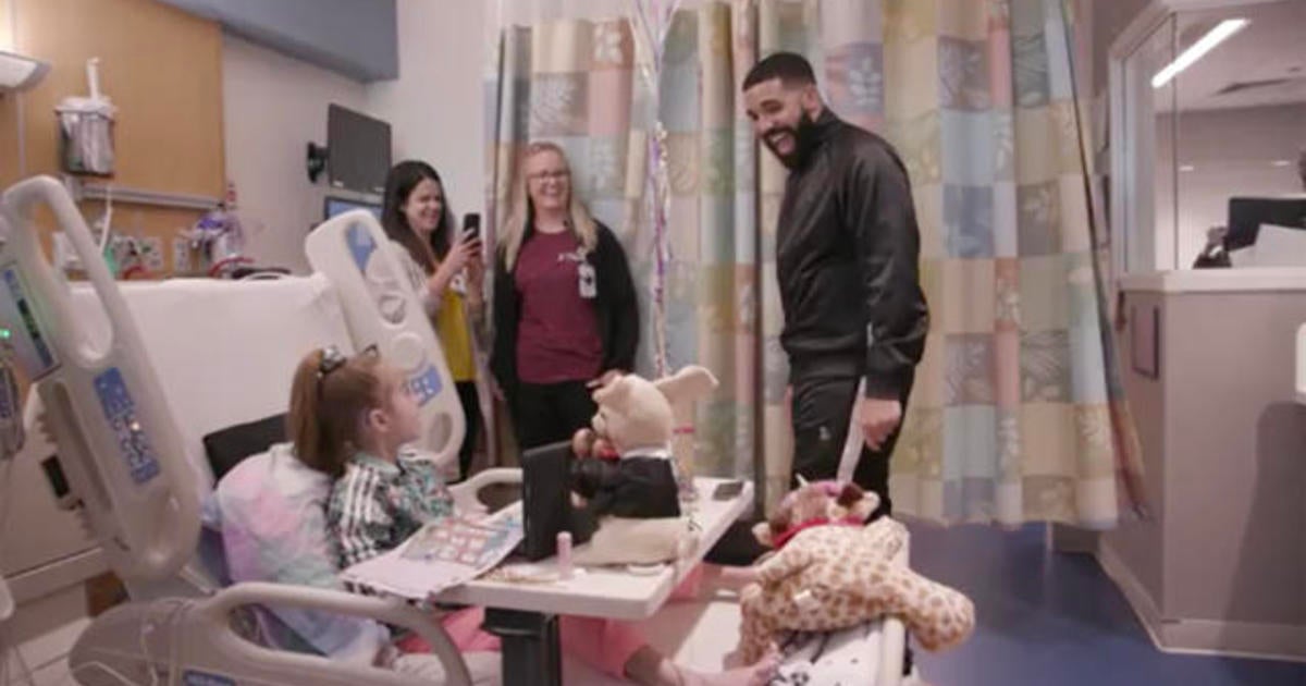 Drake surprises 11-year-old girl waiting for heart transplant in hospital - CBS News