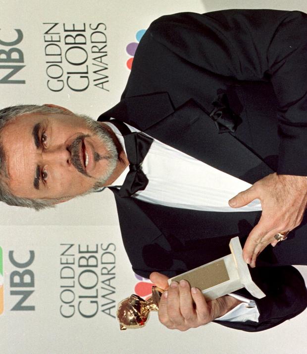 Actor Burt Reynolds holds his Golden Globe Award f 