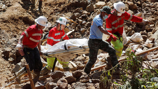 Rescuers carry on a stretcher a cadaver bag containing a body recovered in a landslide caused by Typhoon Mangkhut at a small-scale mining camp in Itogon 