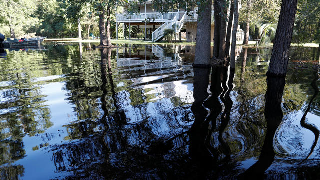 Water from the flooded Waccamaw River surrounds a house in the aftermath of Hurricane Florence now downgraded to a tropical depression in Conway 