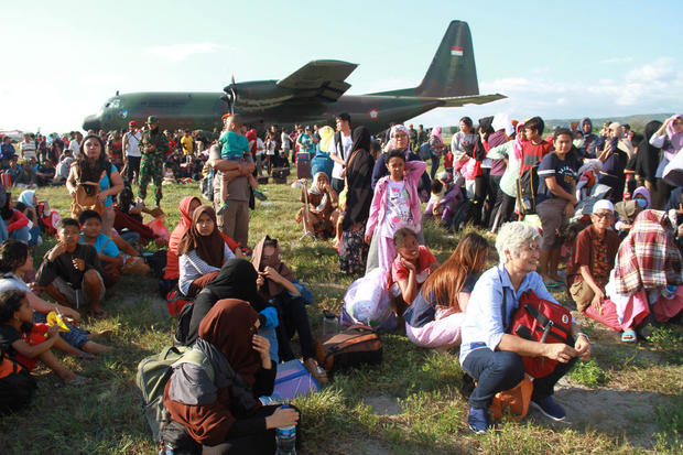 Local residents affected by the earthquake and tsunami wait to be airlifted by military planes at Mutiara Sis Al Jufri Airport in Palu, Central Sulawesi 