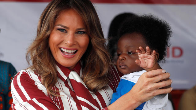 U.S. first lady Melania Trump holds a child during a visit to a hospital in Accra, Ghana 