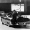 President John F. Kennedy slumps down in the back seat of the presidential limousine after he was fatally shot in Dallas on Nov. 22, 1963. Jacqueline Kennedy leans over the president as Secret Service agent Clinton Hill rides on the back of the car. 