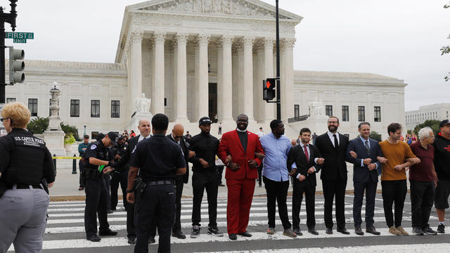 Protestors are arrested for blocking street in front of U.S. Supreme Court while demonstrating against confirmation of Supreme Court nominee Kavanaugh on Capitol Hill in Washington 