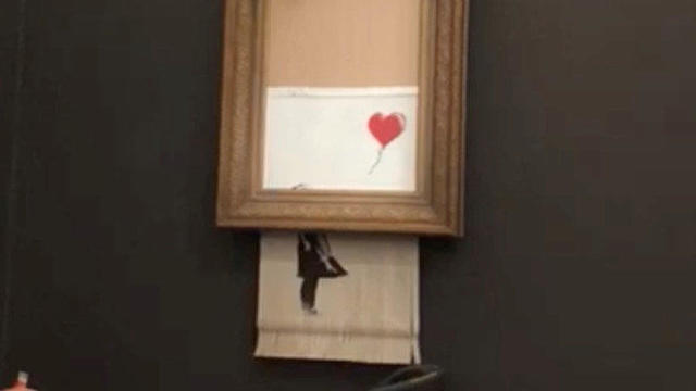 Banksy's painting "Girl with Red Balloon" is seen shredded after its sale at Sotheby auction in London 