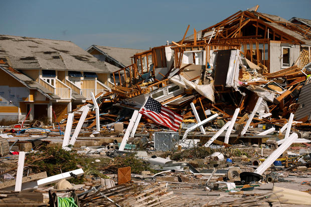An American flag flies amongst rubble left in the aftermath of Hurricane Michael in Mexico Beach 
