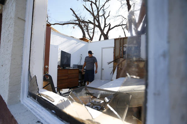 Carlos Pamias inspects his residence damaged by Hurricane Michael in Parker, Florida 