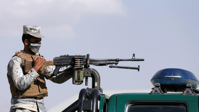 Afghan police officer stands guard at a checkpoint near a polling station in Kabul 