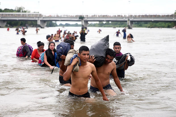 Central American migrants, part of a caravan trying to reach the U.S., cross the Suchiate River to avoid the border checkpoint in Ciudad Hidalgo 