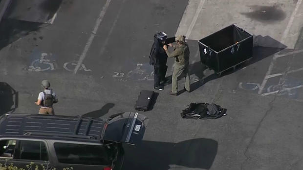 Investigator in bomb suit at Burlingame USPS facility 