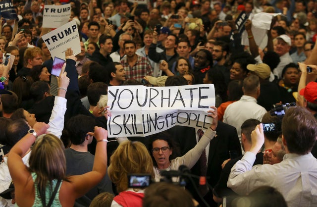 A protestor holds up a sign in the midst of Republican U.S. presidential candidate Donald Trump's campaign rally in New Orleans, Louisiana 