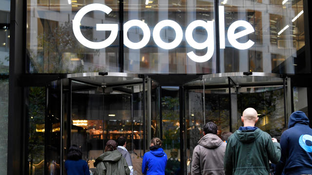 Workers return to the Google offices after walking out as part of a global protest over workplace issues, in London 