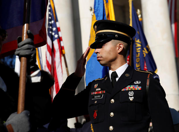 A soldier salutes during ceremonies on Veteran's Day at Arlington National Cemetery in Arlington 