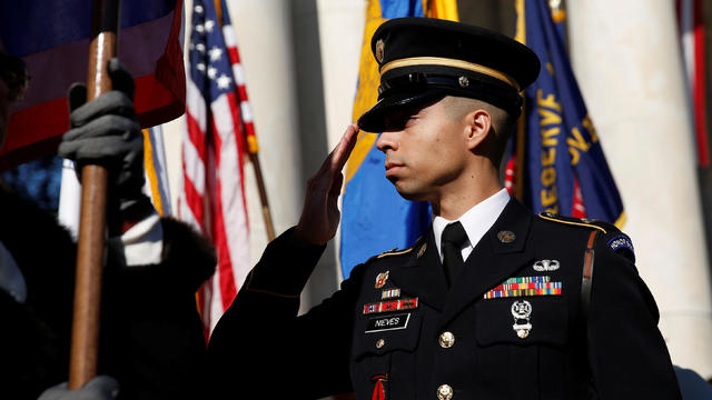 A soldier salutes during ceremonies on Veteran's Day at Arlington National Cemetery in Arlington 