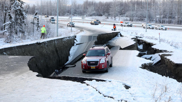 A vehicle lies stranded on a collapsed roadway after an earthquake in Anchorage, Alaska, Nov. 30, 2018. 