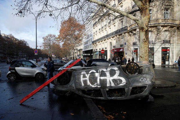 A vandalized car is seen the morning after clashes with protesters wearing yellow vests, a symbol of a French drivers' protest against higher diesel taxes, in Paris 