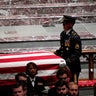 Former U.S. President George W. Bush looks on as casket of former U.S. President George H.W. Bush is carried at conclusion of funeral service in Houston 