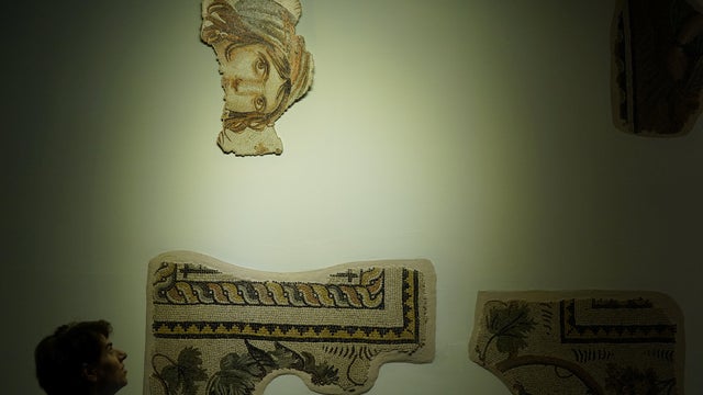 Visitors tour the museum where the missing pieces of the historic "Gypsy Girl" mosaic are on display in an exhibition in Gaziantep 